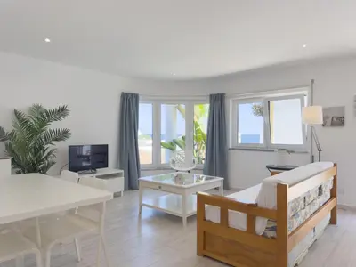 a living room with a couch and a table at Beach Retreat Steps from the Ocean #1953 in Luz