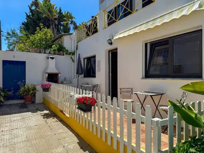 a white fence in front of a house at Beach Retreat Steps from the Ocean #1953 in Luz
