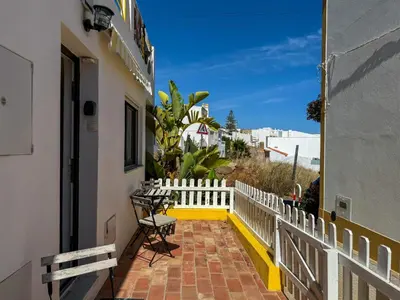 a balcony of a house with a white fence at Beach Retreat Steps from the Ocean #1953 in Luz