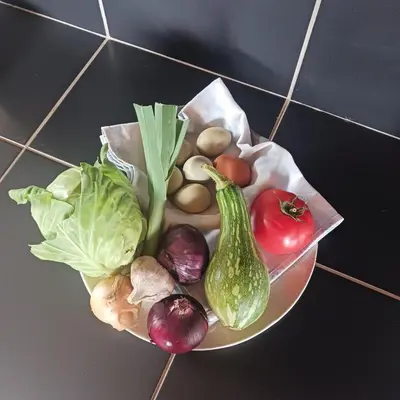 a plate of vegetables sitting on a table at Achadas da Cruz Farm House in Achadas da Cruz