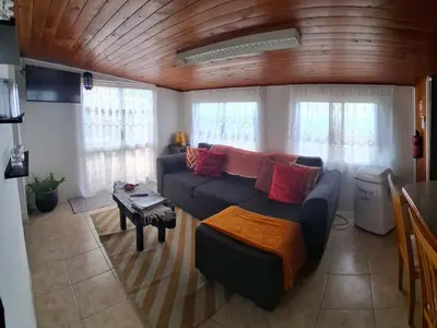 a living room with a couch and a table at Achadas da Cruz Farm House in Achadas da Cruz