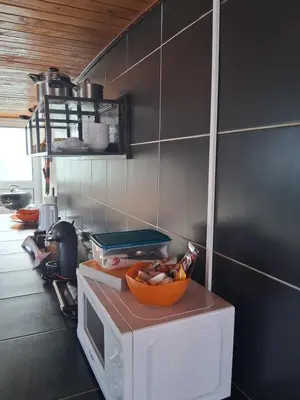 a kitchen with a bowl of food on top of a microwave at Achadas da Cruz Farm House in Achadas da Cruz