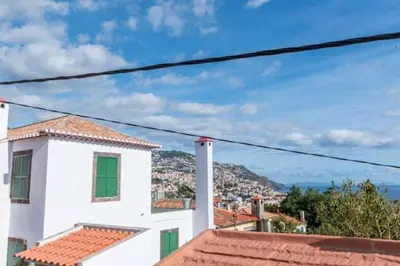 a view of the ocean from the roofs of houses at GuestReady - Aragão Guest house in Funchal