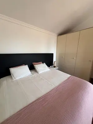 a bedroom with a large bed with two pillows at GuestReady - Aragão Guest house in Funchal