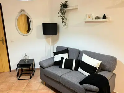 a living room with a gray couch with pillows on it at Eco Natura Falcoeira - Praia da Luz in Montinhos da Luz