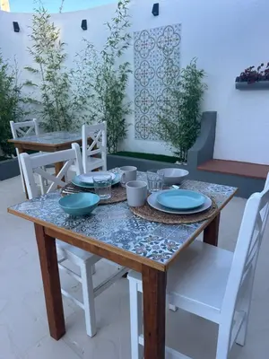 a wooden table with plates and bowls on it at Eco Natura Falcoeira - Praia da Luz in Montinhos da Luz