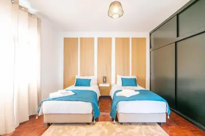 a bedroom with two beds and a window at Lighthouse view- POOL VILLA in Porto Moniz