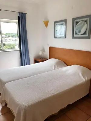 a bedroom with two beds and a window at Bel appartement 2 pieces, bord de mer et vue mer in Lagos