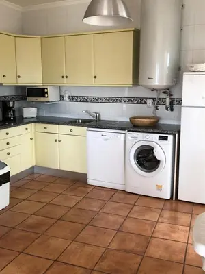a kitchen with a washing machine and a washer at Bel appartement 2 pieces, bord de mer et vue mer in Lagos