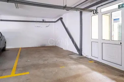 a garage with a door and a car parked in it at Moniz Centro I in Porto Moniz
