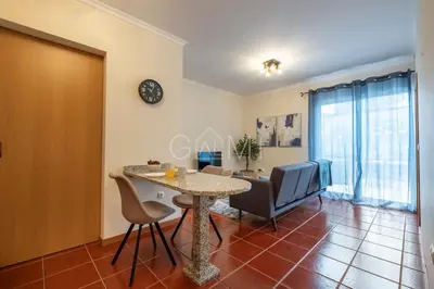 a living room with a table and chairs at Moniz Centro I in Porto Moniz