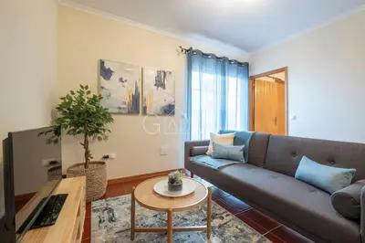 a living room with a couch and a table at Moniz Centro I in Porto Moniz