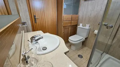 a bathroom with a sink and a toilet at Garajau Paradise Apartment in Caniço
