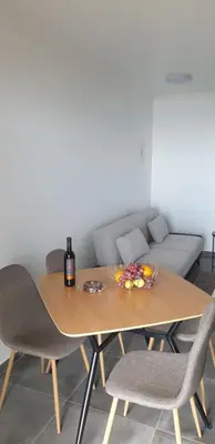 a dining room table with chairs and a couch at Quinta Das Rosas 5 in Estreito da Calheta