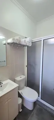a bathroom with a toilet and a sink and a shower at Quinta Das Rosas 5 in Estreito da Calheta