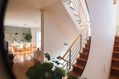 a staircase in a house with a dining room at GuestReady - TiClara Villa & Studio in Caniço