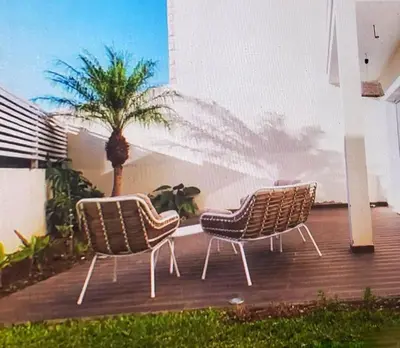three chairs sitting on a deck with a palm tree at GuestReady - TiClara Villa & Studio in Caniço