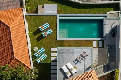 an overhead view of a swimming pool next to a house at Islander - Funchal Seaside Villas in Funchal