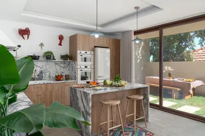 a kitchen with a island with bar stools at Islander - Funchal Seaside Villas in Funchal