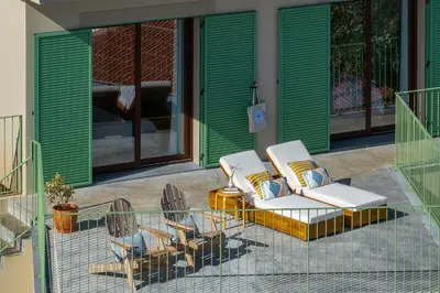 two chairs and a table on a patio at Islander - Funchal Seaside Villas in Funchal