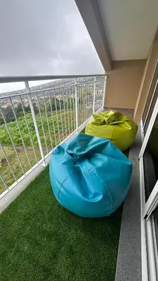 a balcony with two bean bag chairs on the floor at Casa Malee in Calheta