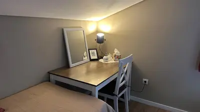 a dressing table with a mirror and a chair in a room at Casa Malee in Calheta