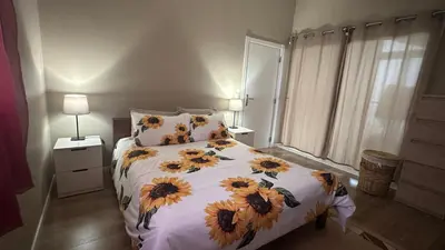 a bedroom with a bed with sunflowers on it at Casa Malee in Calheta