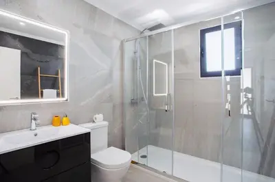 a bathroom with a shower and a toilet and a sink at Pena View Villa in Santa Cruz