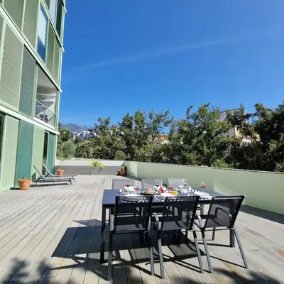 a black table and chairs on a deck with at Upscale, spacious & peacefull 3-bedroom apartment in Funchal