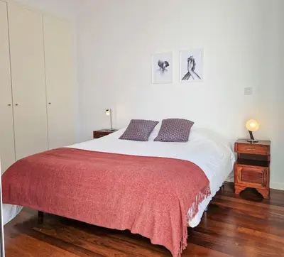a bedroom with a large bed with a red blanket at Upscale, spacious & peacefull 3-bedroom apartment in Funchal