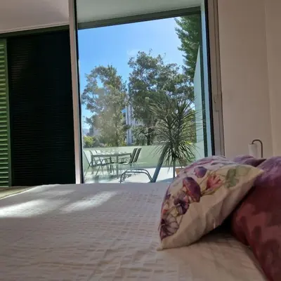 a bedroom with a bed and a large glass window at Upscale, spacious & peacefull 3-bedroom apartment in Funchal