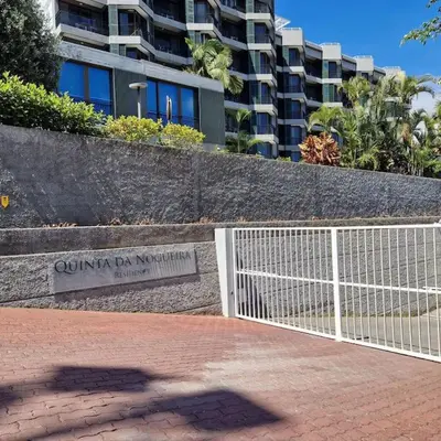 a sign in front of a building with a fence at Upscale, spacious & peacefull 3-bedroom apartment in Funchal