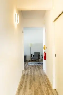 an empty hallway with a chair in a room at Enjoy the city center at fully equipped 2 BR 5 Min walk to beach & market in Funchal