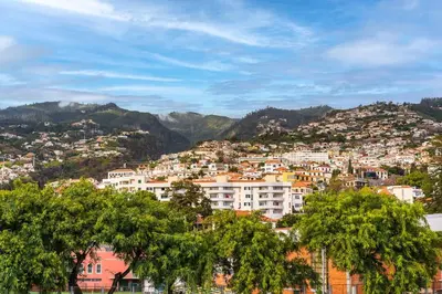 a cityscape of a city with houses and mountains at Enjoy the city center at fully equipped 2 BR 5 Min walk to beach & market in Funchal