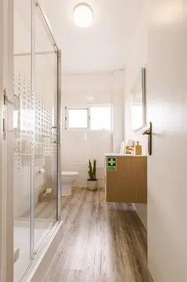 a bathroom with a glass shower and a toilet at Enjoy the city center at fully equipped 2 BR 5 Min walk to beach & market in Funchal