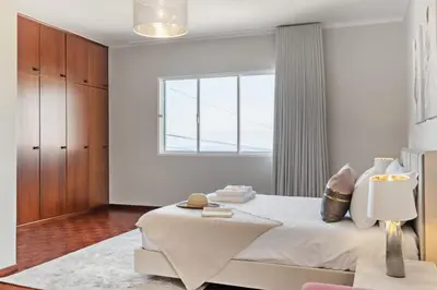 a white bedroom with a bed and a window at Glimpse of the City by Homie in Funchal