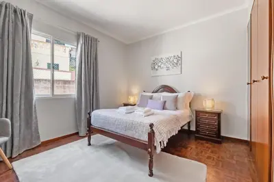 a bedroom with a bed and a window at Glimpse of the City by Homie in Funchal