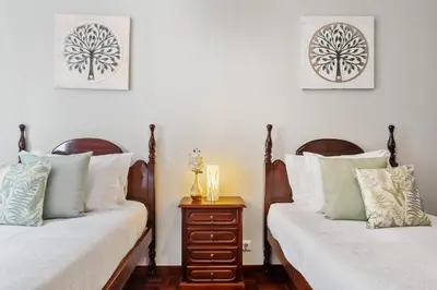 two beds sitting next to each other in a bedroom at Glimpse of the City by Homie in Funchal