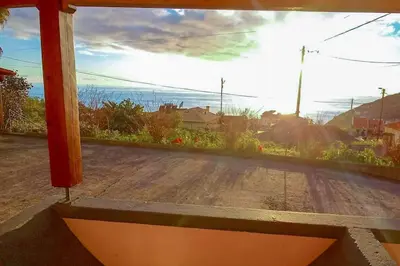 a window with a view of a dirt road at The funny and Relax apartment with terrace & view in Arco da Calheta
