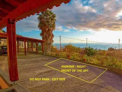a sign that says parking right front of the art at The funny and Relax apartment with terrace & view in Arco da Calheta