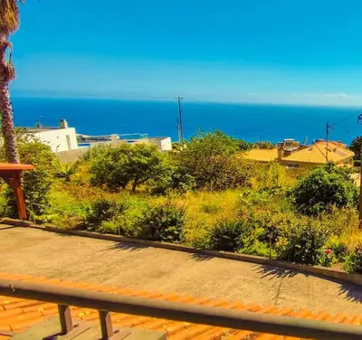a view of the ocean from a bench at The funny and Relax apartment with terrace & view in Arco da Calheta