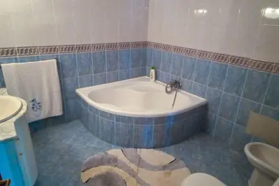 a bathroom with a tub and a toilet and a sink at The funny and Relax apartment with terrace & view in Arco da Calheta