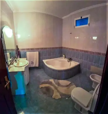 a bathroom with a tub and a toilet and a sink at The funny and Relax apartment with terrace & view in Arco da Calheta