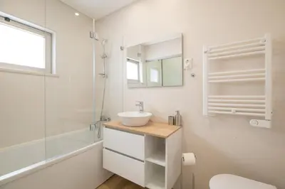 a bathroom with a sink and a shower and a mirror at Luz Secret by MOJE Holiday in Luz