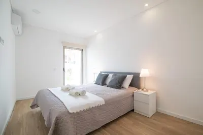 a white bedroom with a bed with two stuffed animals on it at Luz Secret by MOJE Holiday in Luz