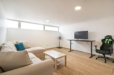 a living room with a couch and a chair and a television at Luz Secret by MOJE Holiday in Luz