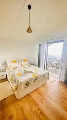 a bedroom with a bed with a view of the ocean at BoaVista- 2 bed house -COSY PANORAMIC -SEA - MOUNTAIN VIEW in Campanário