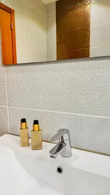 a bathroom sink with two bottles of soap on it at BoaVista- 2 bed house -COSY PANORAMIC -SEA - MOUNTAIN VIEW in Campanário