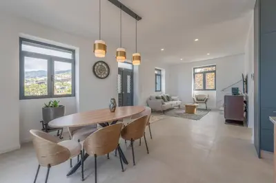 a dining room and living room with a table and chairs at FLH Papaya Villa with Sea View in Funchal