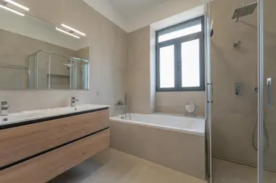 a bathroom with a tub and a sink and a shower at FLH Papaya Villa with Sea View in Funchal